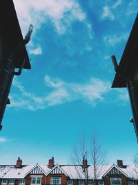 Low angle view of building against cloudy sky