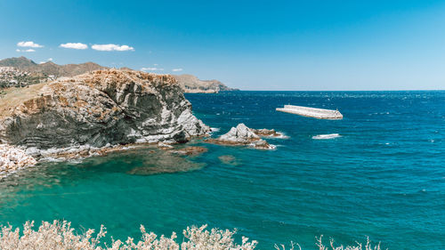 Scenic view of sea against blue sky