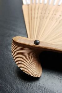 Close-up of hand fan on table