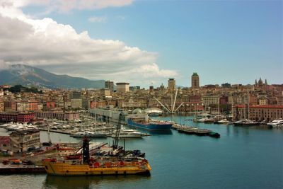 Boats in river with city in background