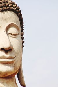 Close-up of statue against temple against clear sky