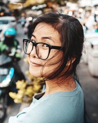 Portrait of smiling woman wearing eyeglasses on street