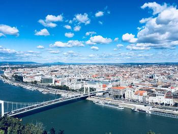 High angle view of river amidst cityscape against sky