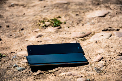 Close-up of sunglasses on sand