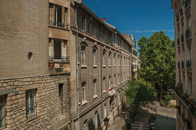 Apartment buildings and gardens in a street of montmartre at paris. the famous capital of france.