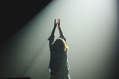 Woman standing in the dark