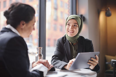 Two businesswomen sitting in cafe