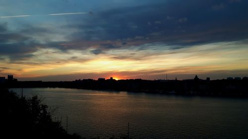 Scenic view of river at sunset