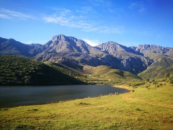 Scenic view of lake and mountains against sky