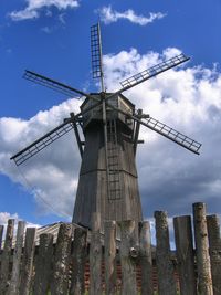 Low angle view of traditional windmill against sky