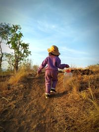 Full length of girl sitting on field