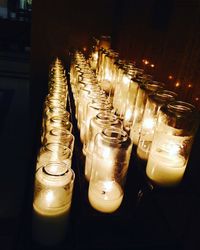 Row of illuminated candles in temple