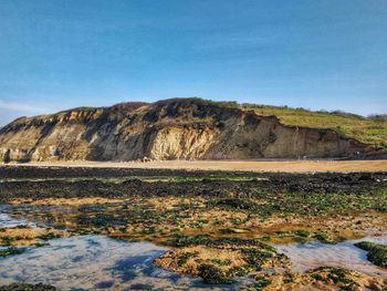 Scenic view of rocky mountains against clear blue sky