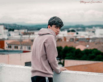 Full length of a man standing against cityscape