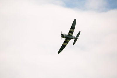 Close-up of airplane flying against clear sky