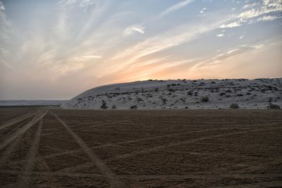 Scenic view of desert against sky during sunset