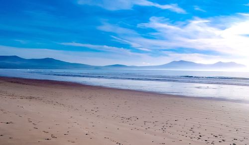 Scenic view of beach against blue sky