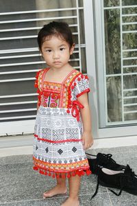 Portrait of girl standing by window