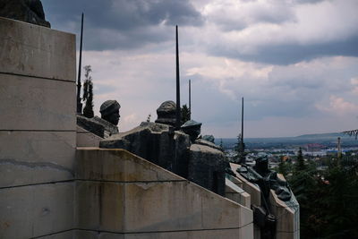 Statue of buildings against cloudy sky