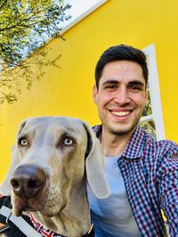 Portrait of young man with dog