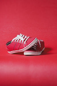 Close-up of shoes on red surface