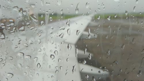Full frame shot of wet glass window in rainy season
