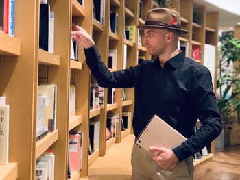 Side view of man working in library