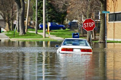 Police car floating on water during flood