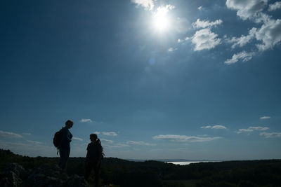 People standing on land against sky