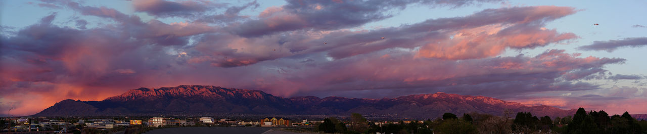 Panoramic view of mountains against sky at sunset