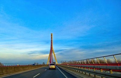 Bridge over road against blue sky