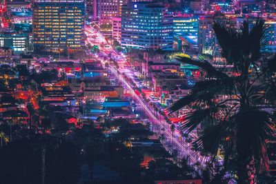 Illuminated cityscape against sky at night