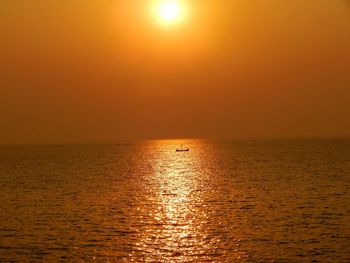 Scenic view of sea against orange sky