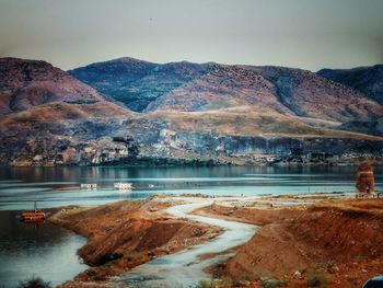 Scenic view of lake with mountain range in background