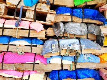 Multi colored tied up pallets stacked at warehouse