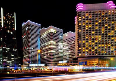 Illuminated buildings against sky in city at night