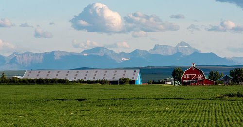House on field against mountain