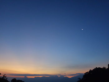 Low angle view of moon in sky at night