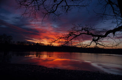 Scenic view of lake against orange sky