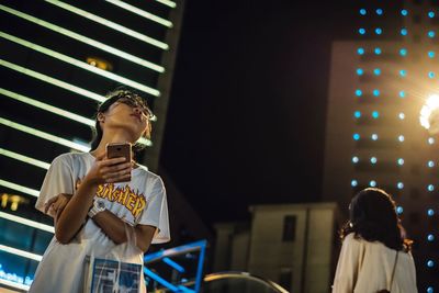 Low angle view of woman looking at camera