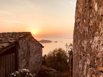 Sunset in greece over the sea and an old house.