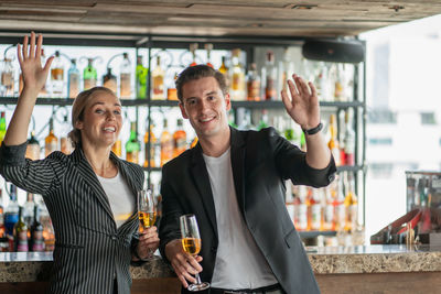 Happy young woman drinking glasses at restaurant