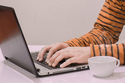 Midsection of coffee cup on table