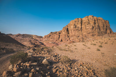 Rock formations against clear blue sky