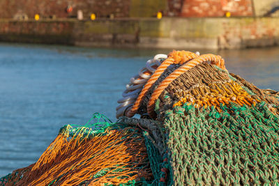 Fishing net at harbor during sunny day