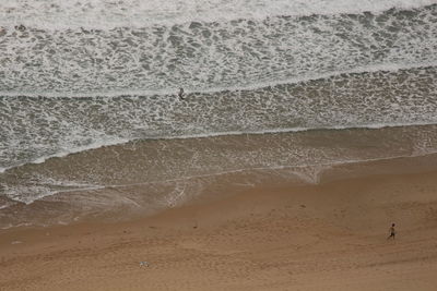 Sand dunes at beach against sky