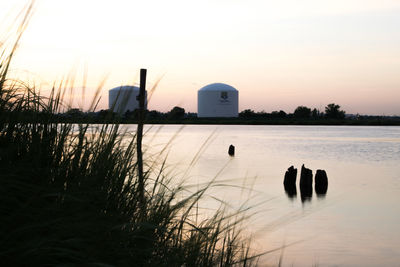 Scenic view of calm lake at sunset