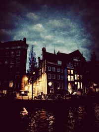 Illuminated buildings against sky at night