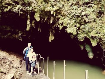 Rear view of man walking in cave