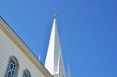 Low angle view of skyscraper against clear blue sky